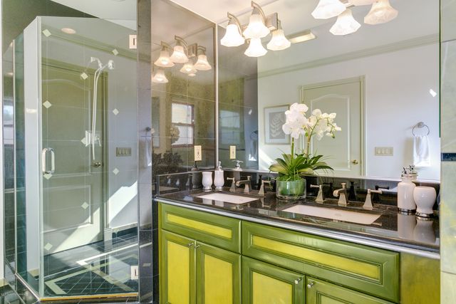a bathroom with a sink mirror and a shower