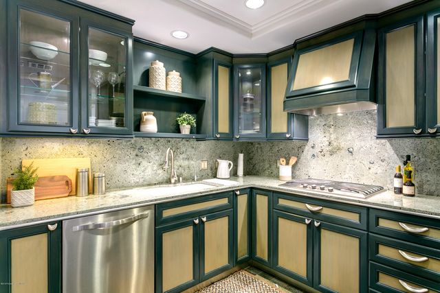 a kitchen with a sink a stove and cabinets