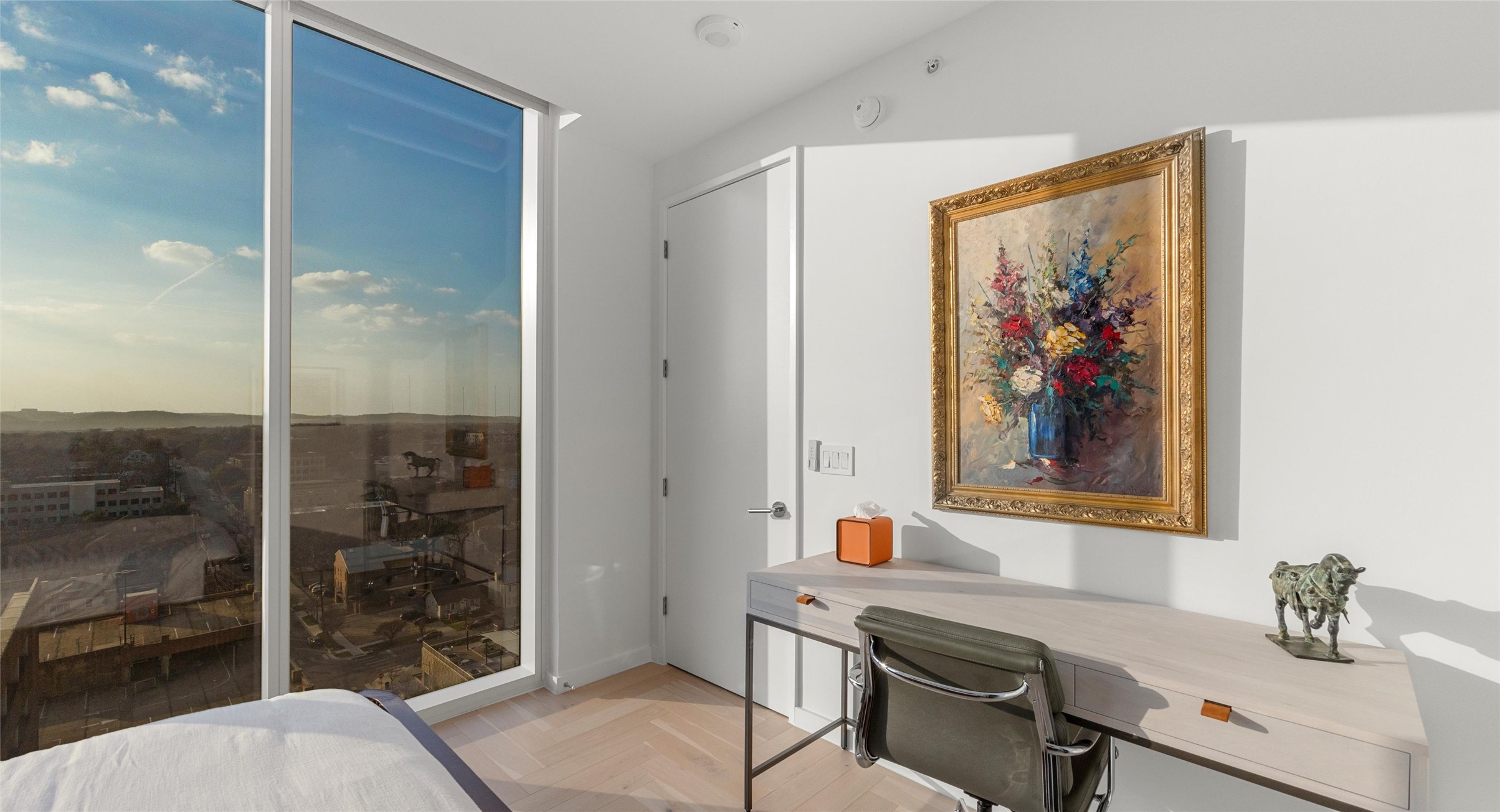 313 West 17th Street, Unit 1104 Austin, TX 78701 - Photo 38 of 40 Bright and versatile second bedroom with floor-to-ceiling windows that capture breathtaking sunsets over the Hill Country. A flexible space that easily transitions into a guest room, home office, or creative retreat.