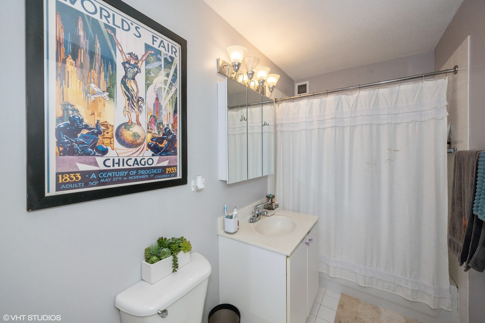 2 East Erie Street, Unit 1606 Chicago, IL 60611 - Photo 12 of 13 a bathroom with a shower curtain and a sink
