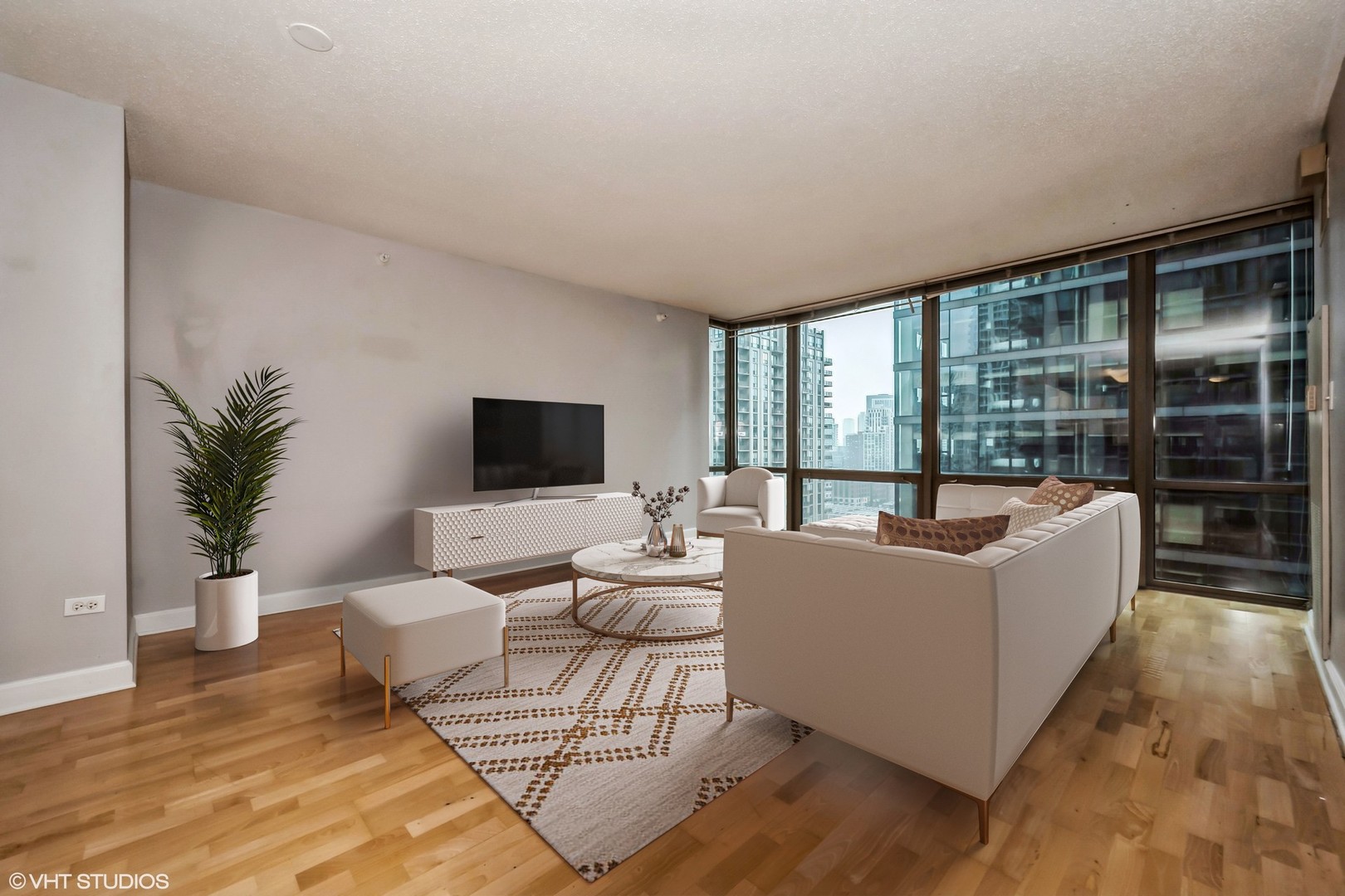 2 East Erie Street, Unit 1606 Chicago, IL 60611 - Photo 3 of 13 a living room with furniture and large windows