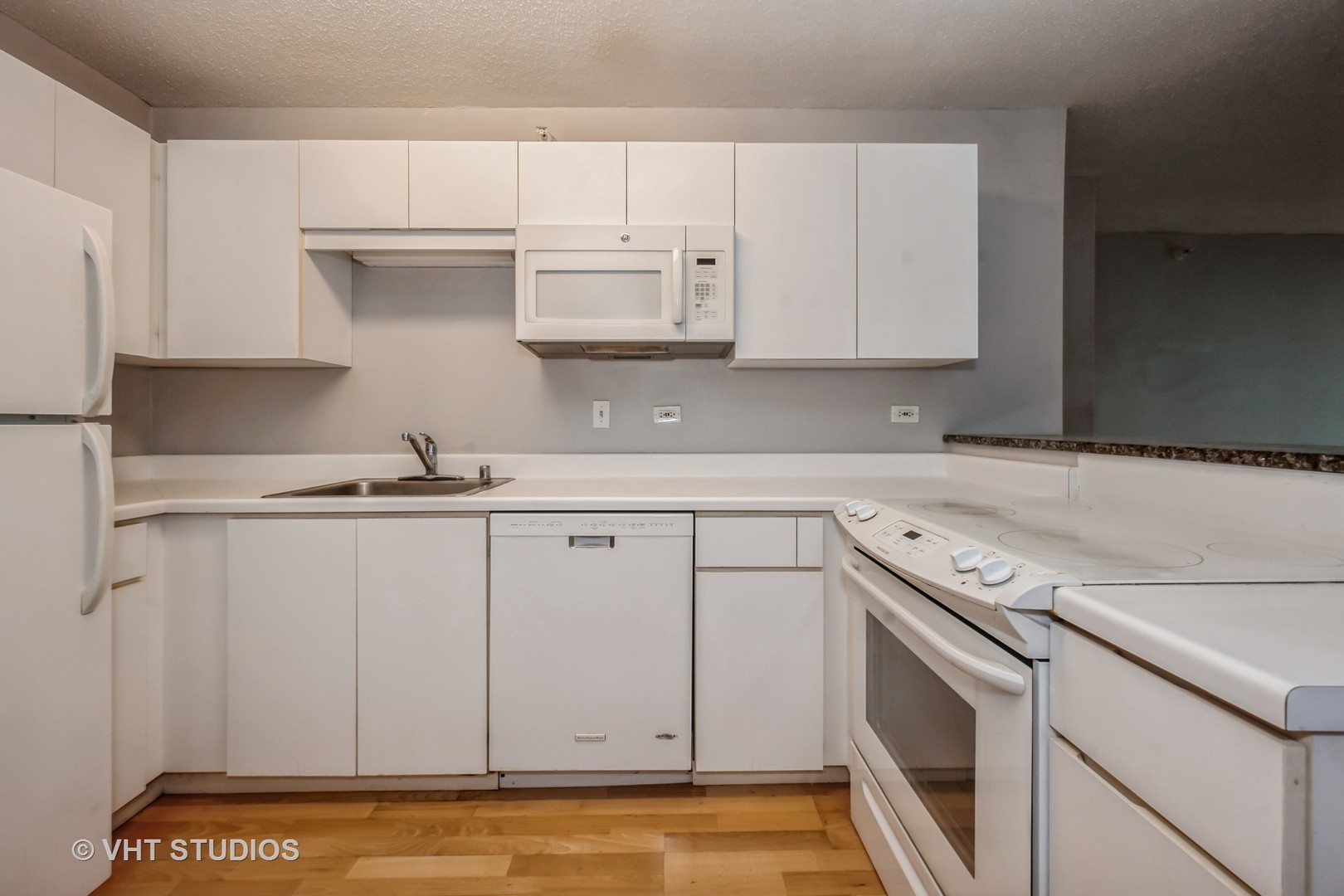2 East Erie Street, Unit 1606 Chicago, IL 60611 - Photo 7 of 13 a kitchen with white cabinets and sink