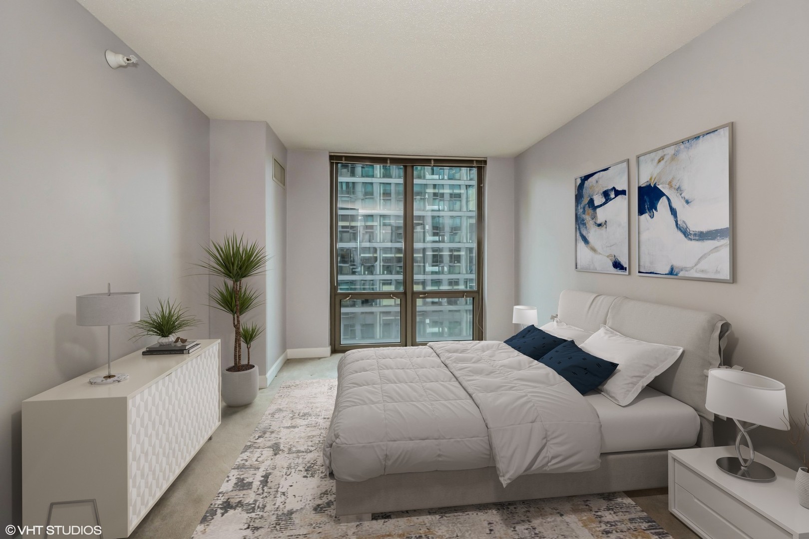 2 East Erie Street, Unit 1606 Chicago, IL 60611 - Photo 8 of 13 a bedroom with a large bed and a window