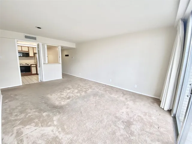 an empty room with closet and windows