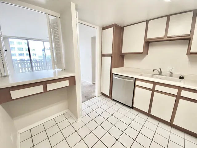 a kitchen with stainless steel appliances a sink and a cabinets