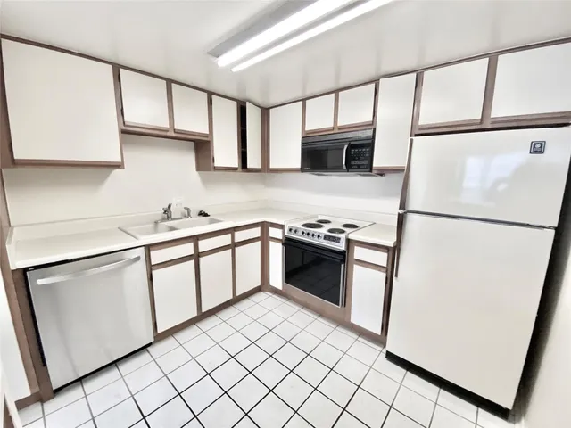 a kitchen with stainless steel appliances a refrigerator sink and microwave
