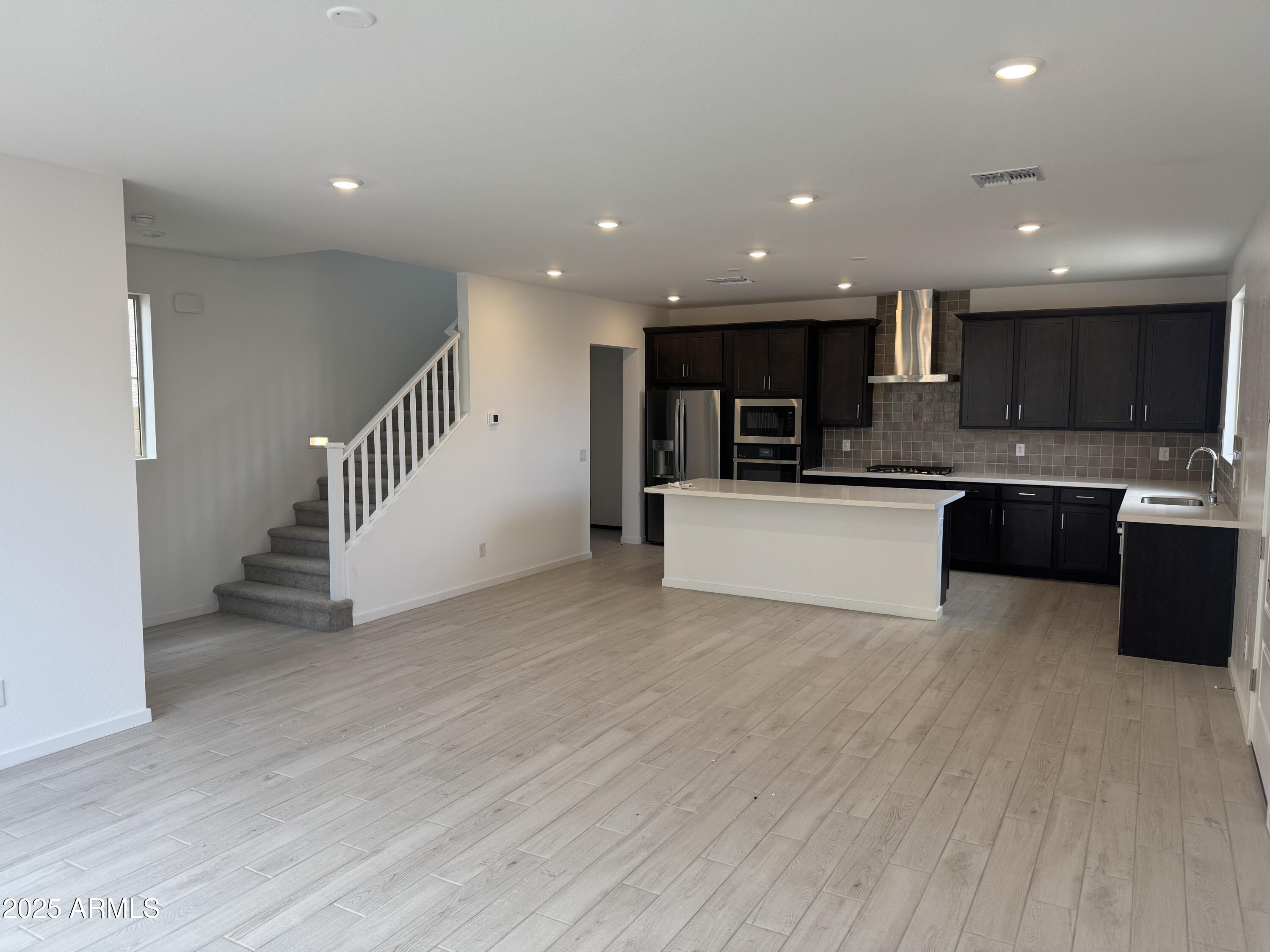 2463 West Rowel Road Phoenix, AZ 85085 - Photo 5 of 30 a view of kitchen with wooden floor and electronic appliances