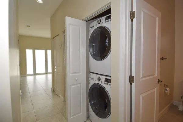 a view of a hallway with washer and dryer