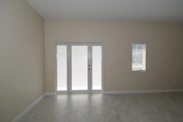 an empty room with windows and closet