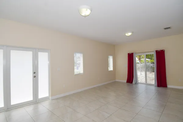 an empty room with windows and closet
