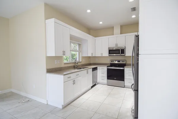 a kitchen with stainless steel appliances a stove sink and microwave