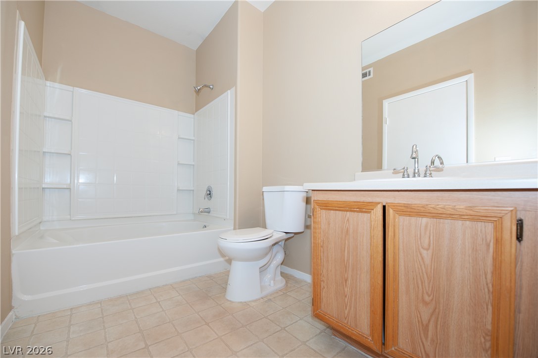 9050 West Warm Springs Road, Unit 1132 Las Vegas, NV 89148 - Photo 14 of 21 Functional bathroom featuring a tub/shower combo and a vanity with ample storage.