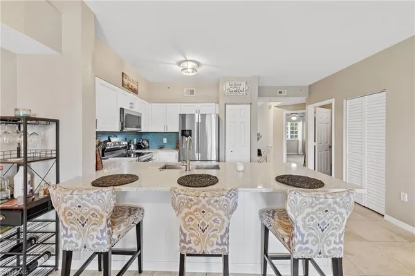 a view of a dining room with furniture and a chandelier