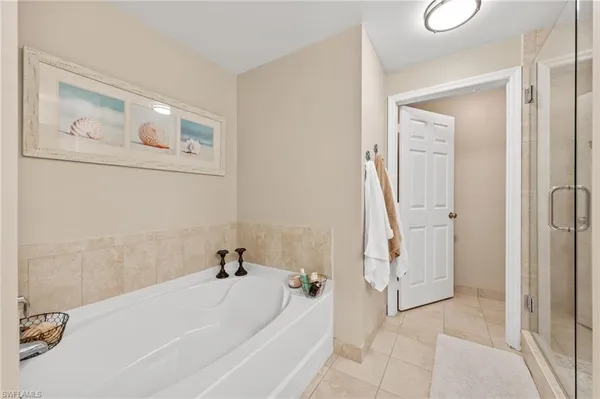 a white bath tub sitting next to a shower