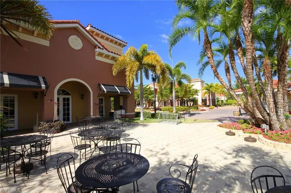 a view of a patio with a dining table and chairs