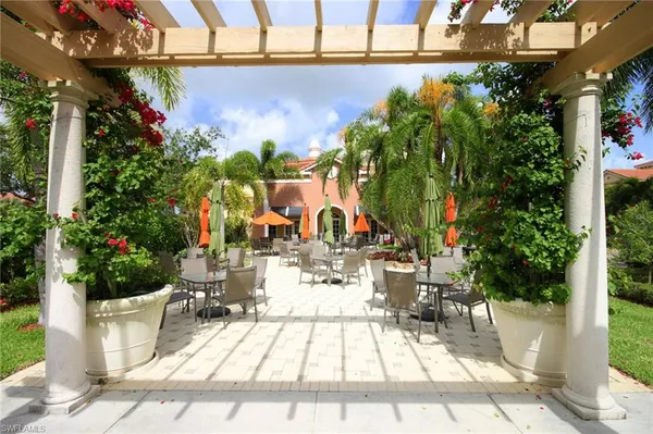 a view of a patio with table and chairs and potted plants