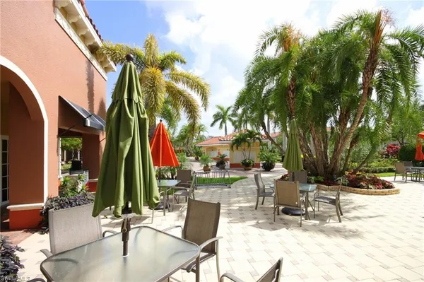 a swimming pool with outdoor seating and a garden