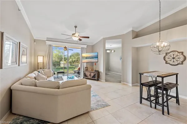 a living room with furniture a fireplace and a chandelier