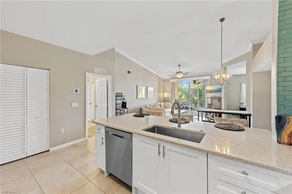 a kitchen with sink and cabinets