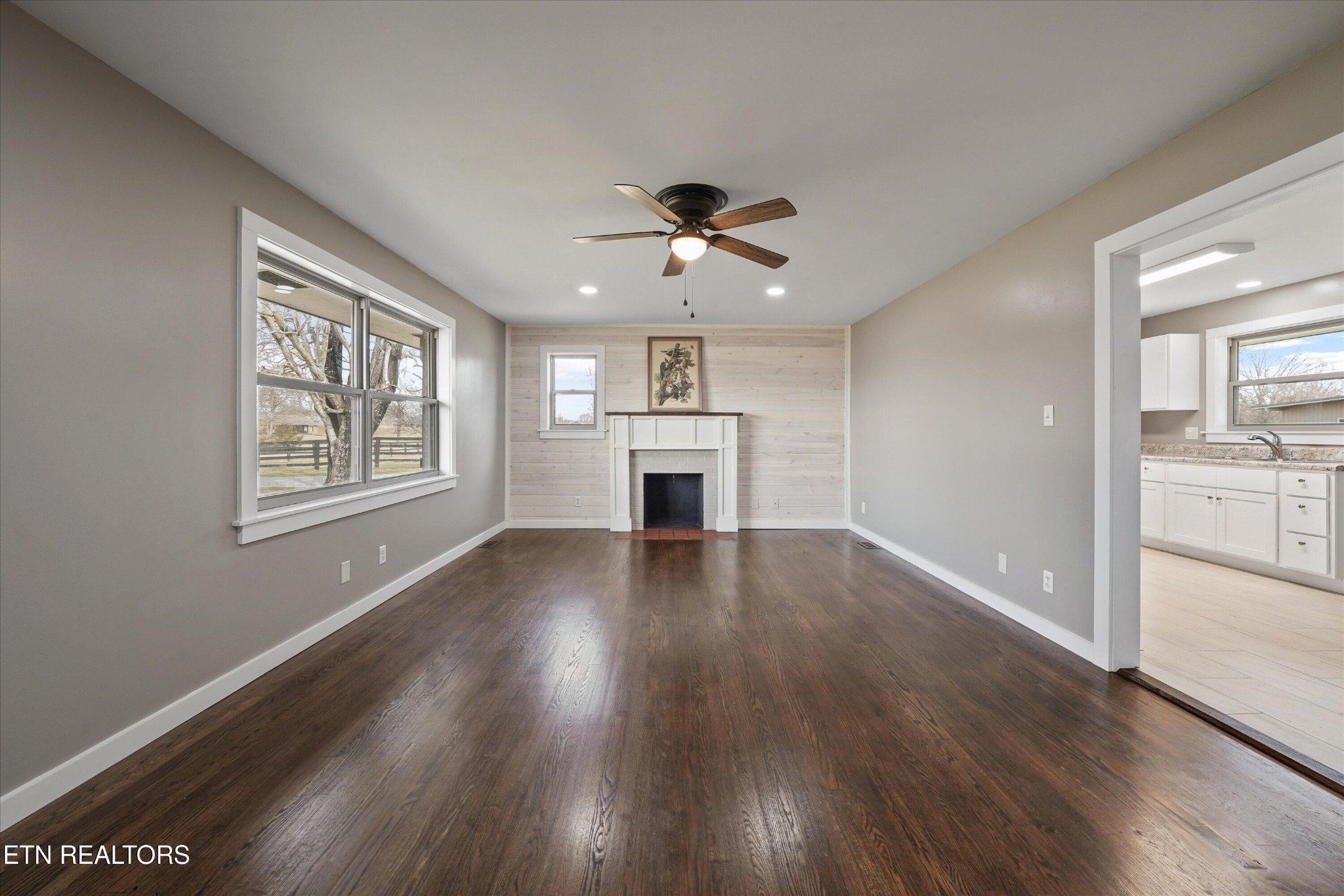 3138 Carpenters Grade Road Maryville, TN 37803 - Photo 17 of 45 a view of an empty room with a kitchen and wooden floor