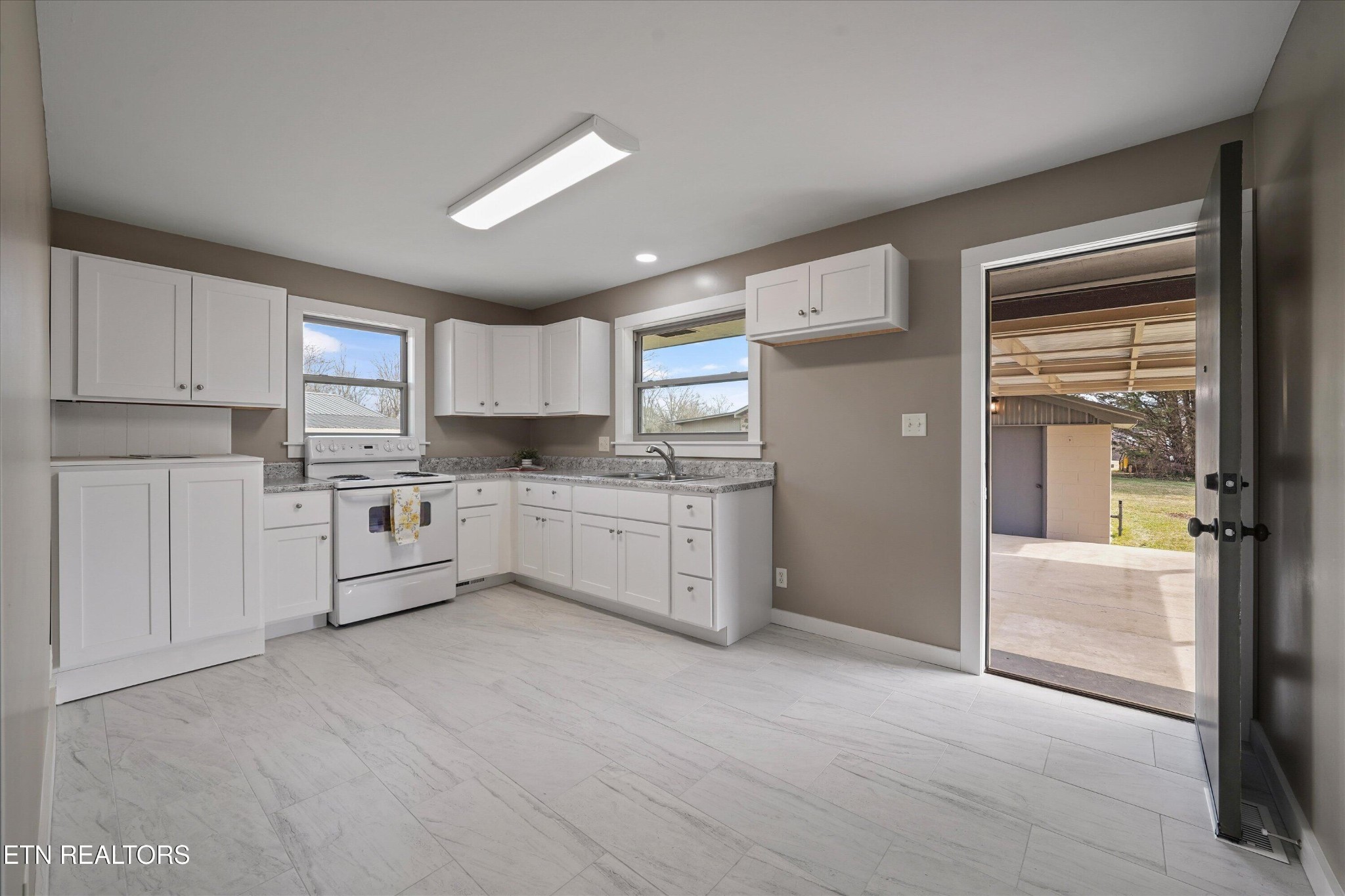 3138 Carpenters Grade Road Maryville, TN 37803 - Photo 20 of 45 a kitchen with stainless steel appliances white cabinets and wooden floors