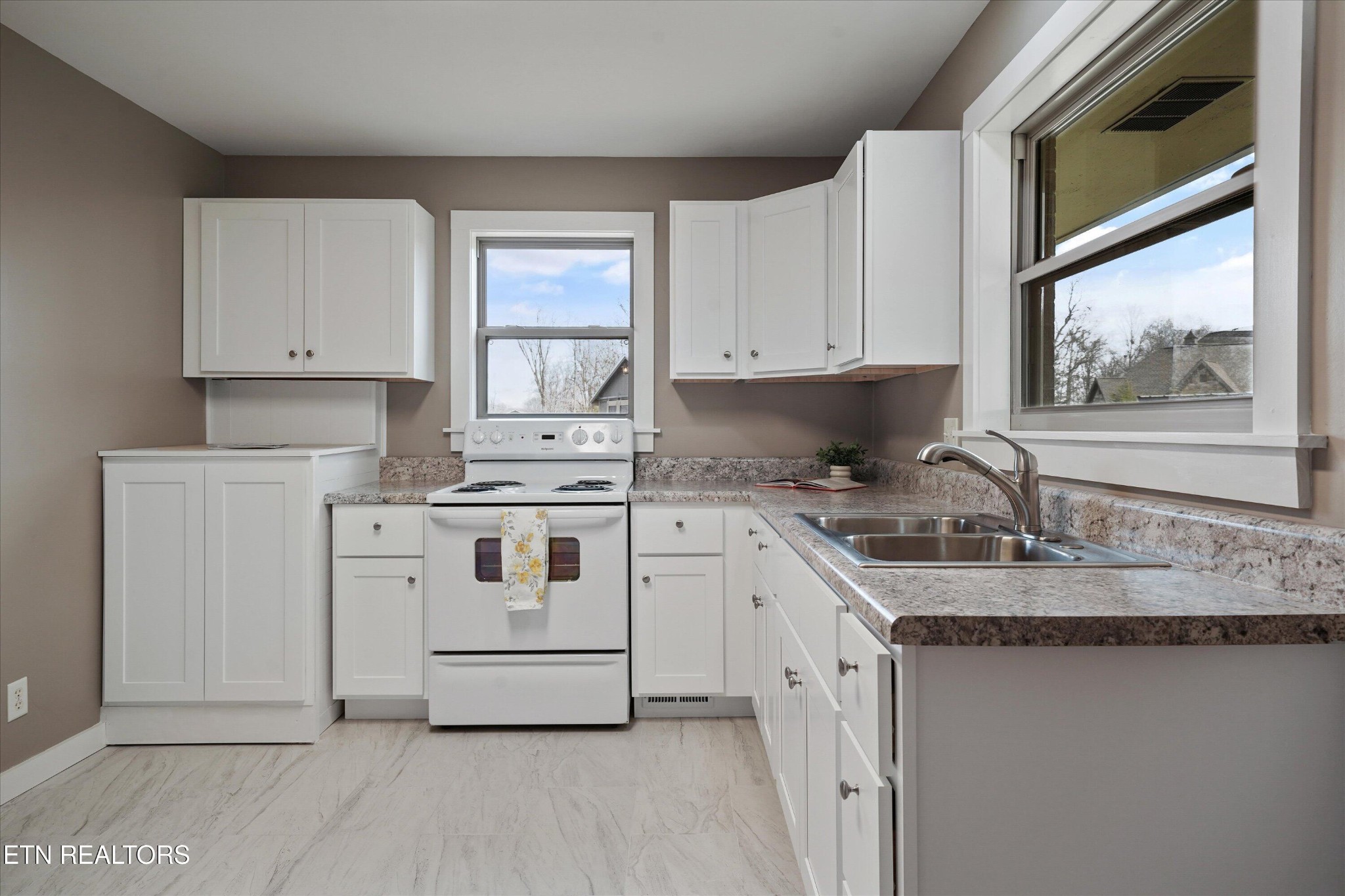 3138 Carpenters Grade Road Maryville, TN 37803 - Photo 21 of 45 a kitchen with granite countertop white cabinets and white appliances