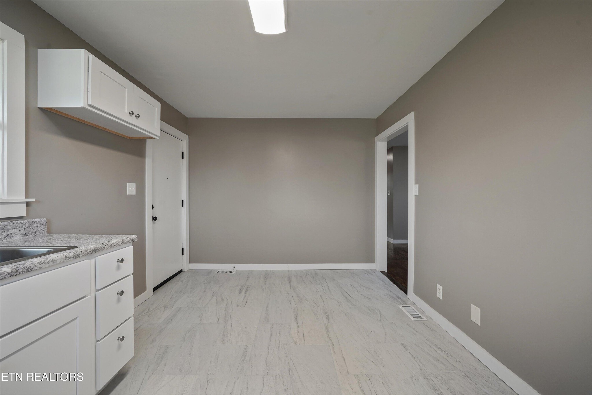 3138 Carpenters Grade Road Maryville, TN 37803 - Photo 24 of 45 a view of a kitchen with white cabinets and wooden floor
