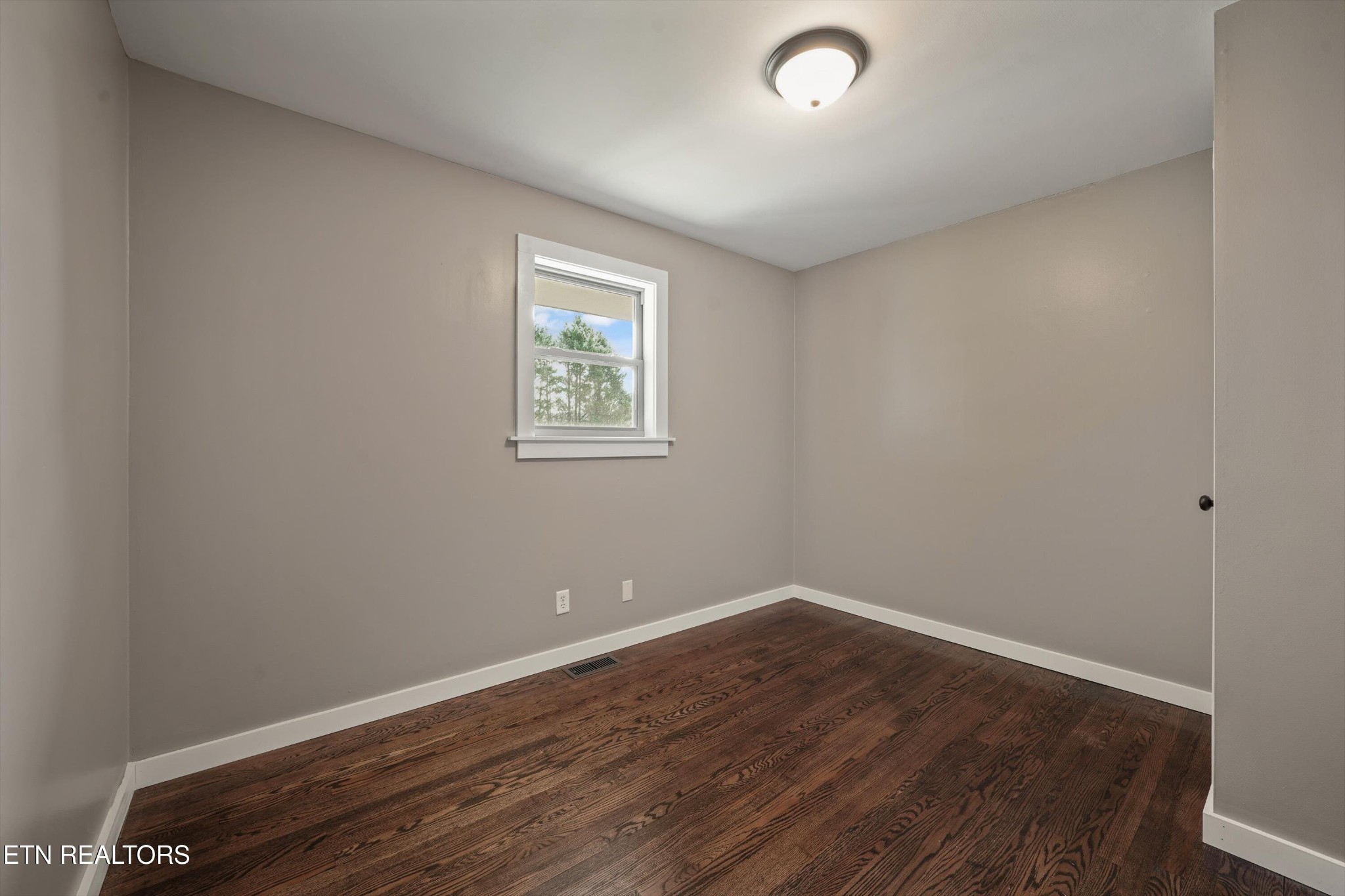 3138 Carpenters Grade Road Maryville, TN 37803 - Photo 28 of 45 an empty room with wooden floor and windows