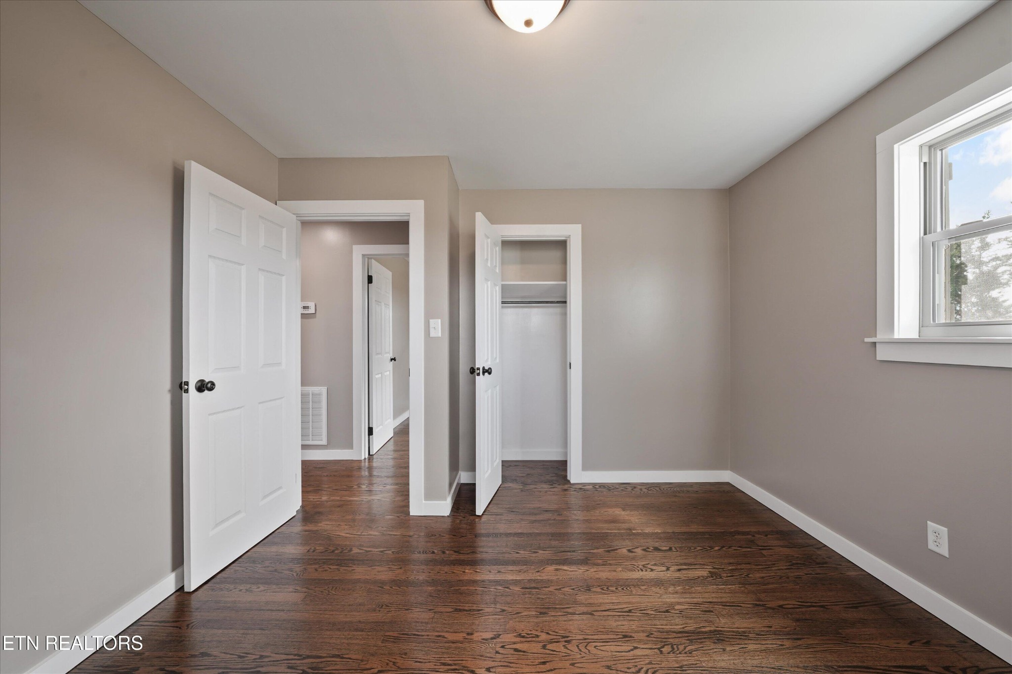 3138 Carpenters Grade Road Maryville, TN 37803 - Photo 30 of 45 a view of an empty room with wooden floor and a window