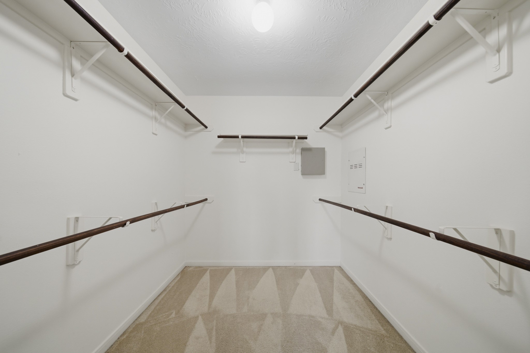 3306 Colleville Sur Mer Lane Spring, TX 77388 - Photo 13 of 30 This impressive walk-in primary closet offers an abundance of storage space with wraparound hanging areas designed to keep wardrobes organized and easily accessible. The expansive layout provides room for seasonal clothing, shoes, accessories, and additional storage solutions.
