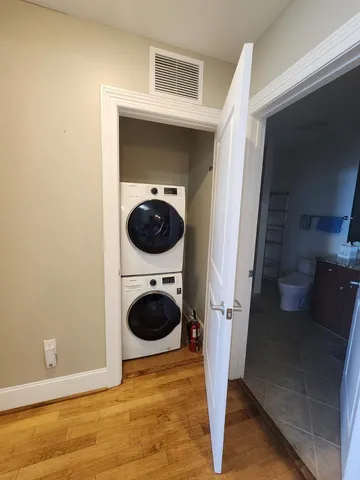 a bathroom with a granite countertop toilet a sink and a shower