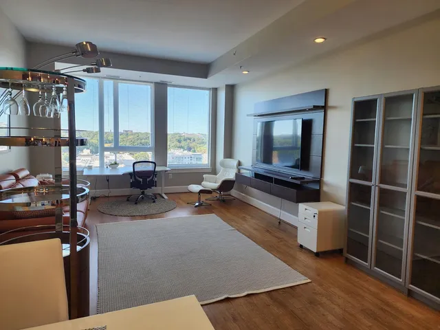 a living room with furniture and a large window