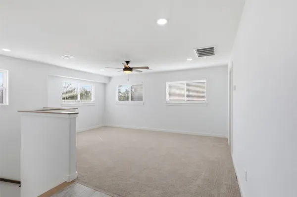 an empty room with windows and closet