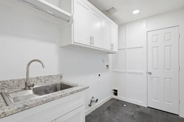 a view of a kitchen sink and cabinets