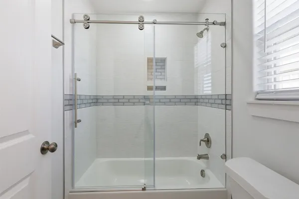 a bathroom with a shower and a bathtub