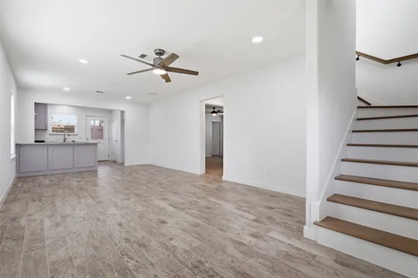 a view of a kitchen with wooden floor and a kitchen