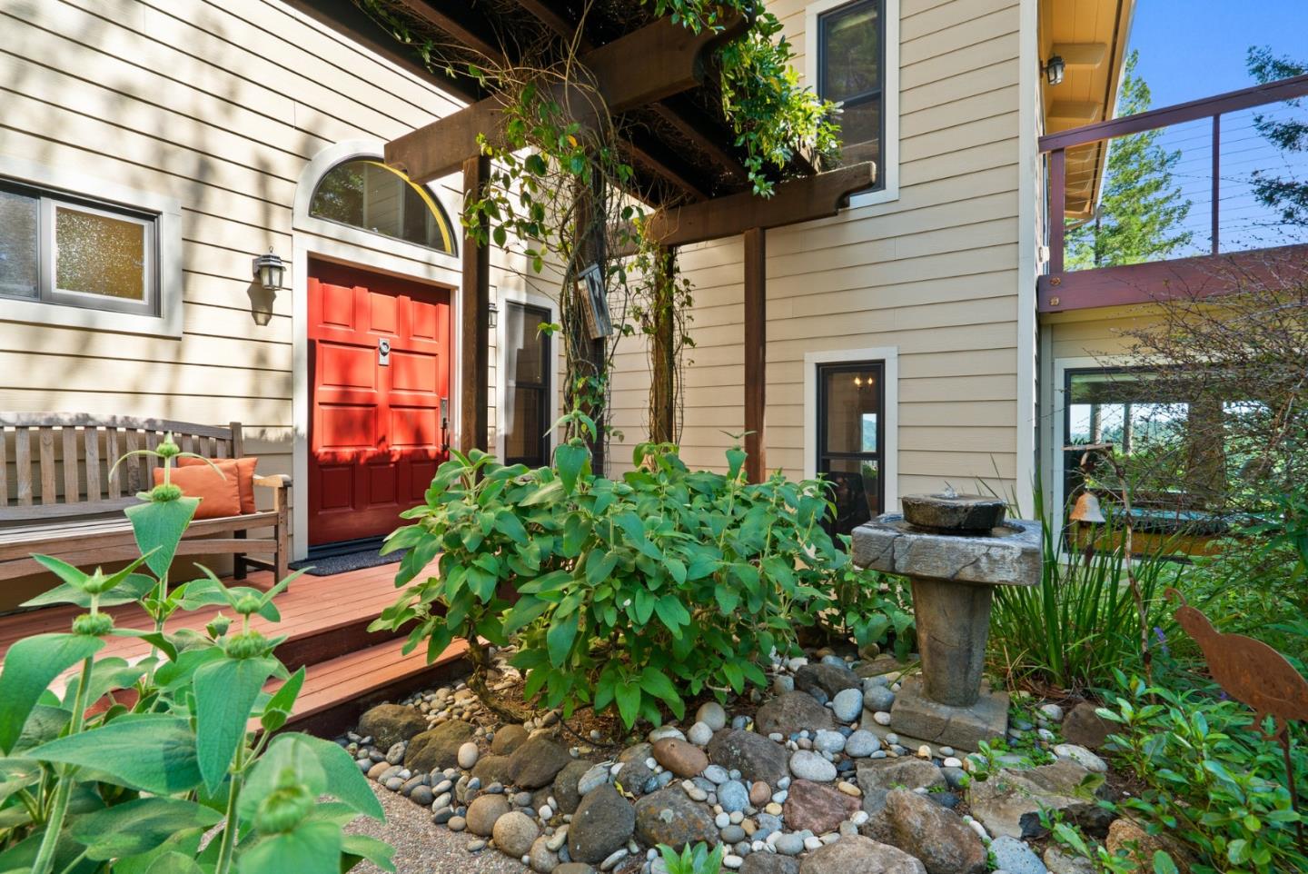 a backyard of a house with a garden and outdoor seating