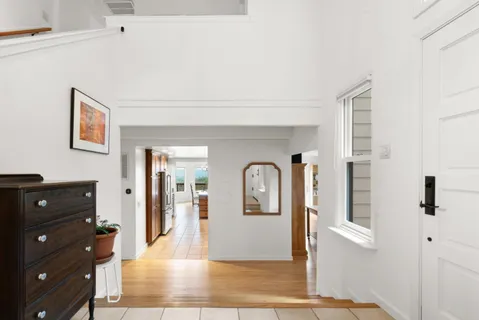a living room with furniture fireplace and a large window