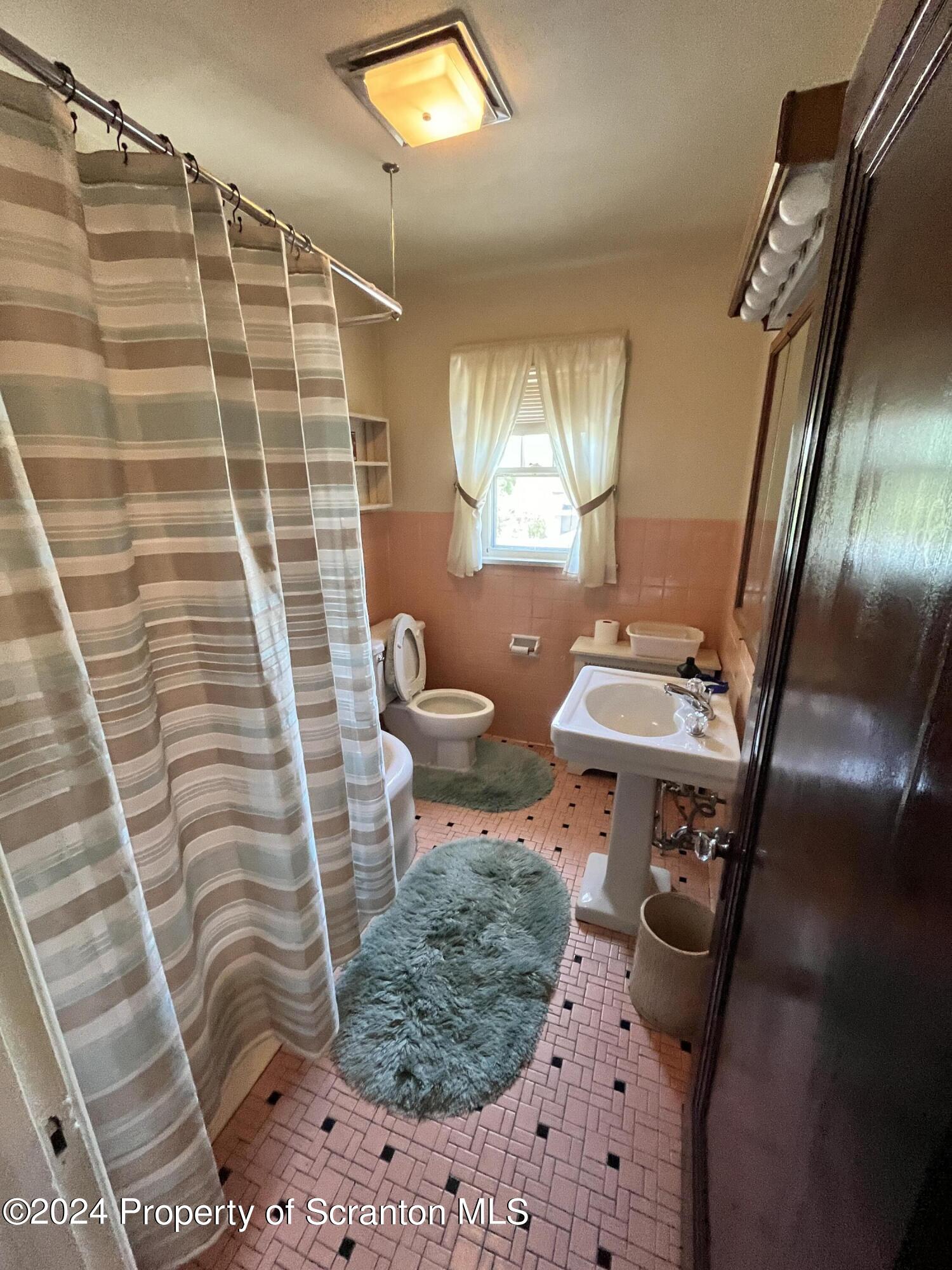 2002 Green Ridge Street Dunmore, PA 18512 - Photo 25 of 43 a bathroom with a sink toilet and shower