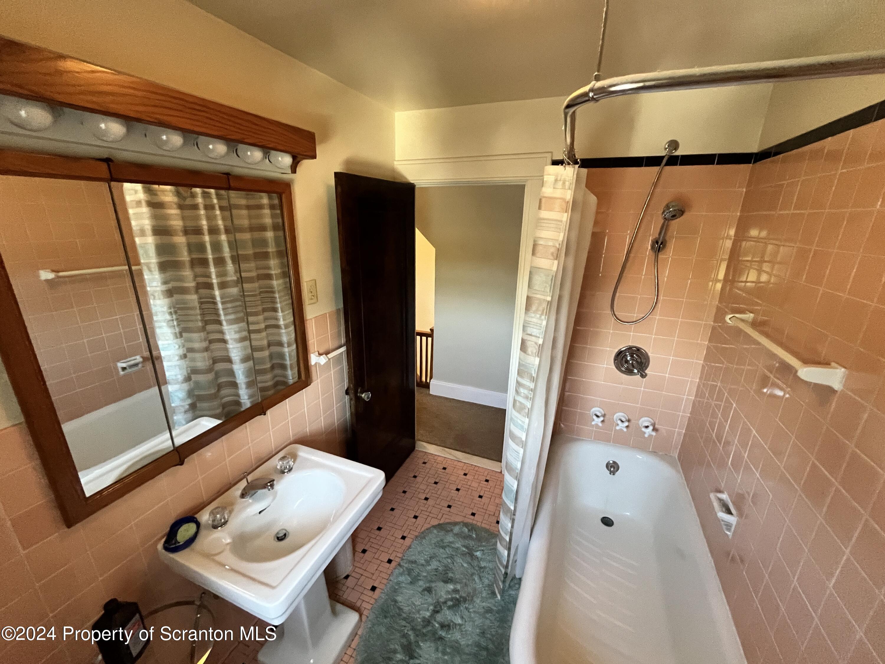 2002 Green Ridge Street Dunmore, PA 18512 - Photo 27 of 43 a bathroom with a tub a sink and glass door shower