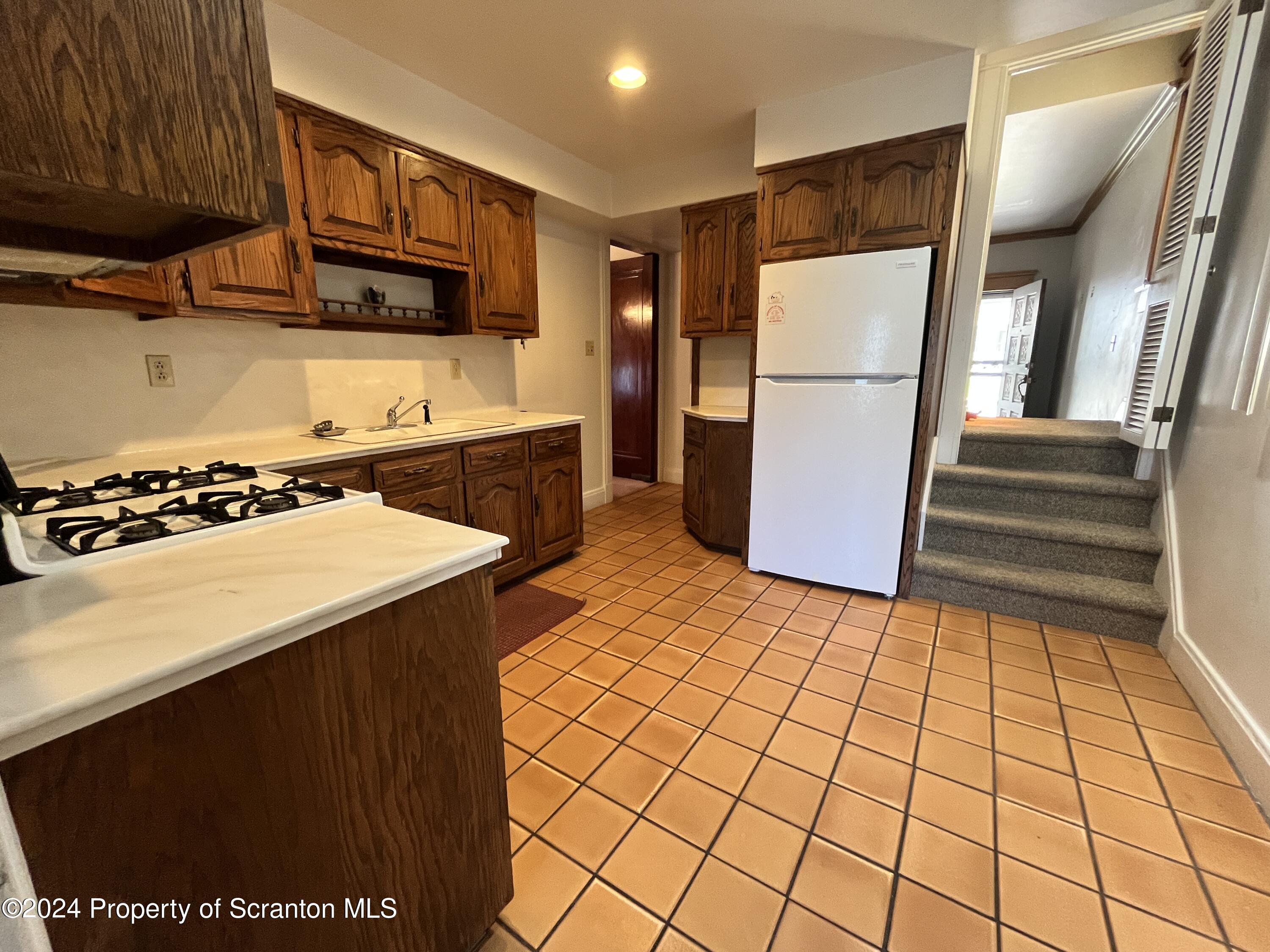 2002 Green Ridge Street Dunmore, PA 18512 - Photo 5 of 43 a kitchen with stainless steel appliances a refrigerator and a stove top oven
