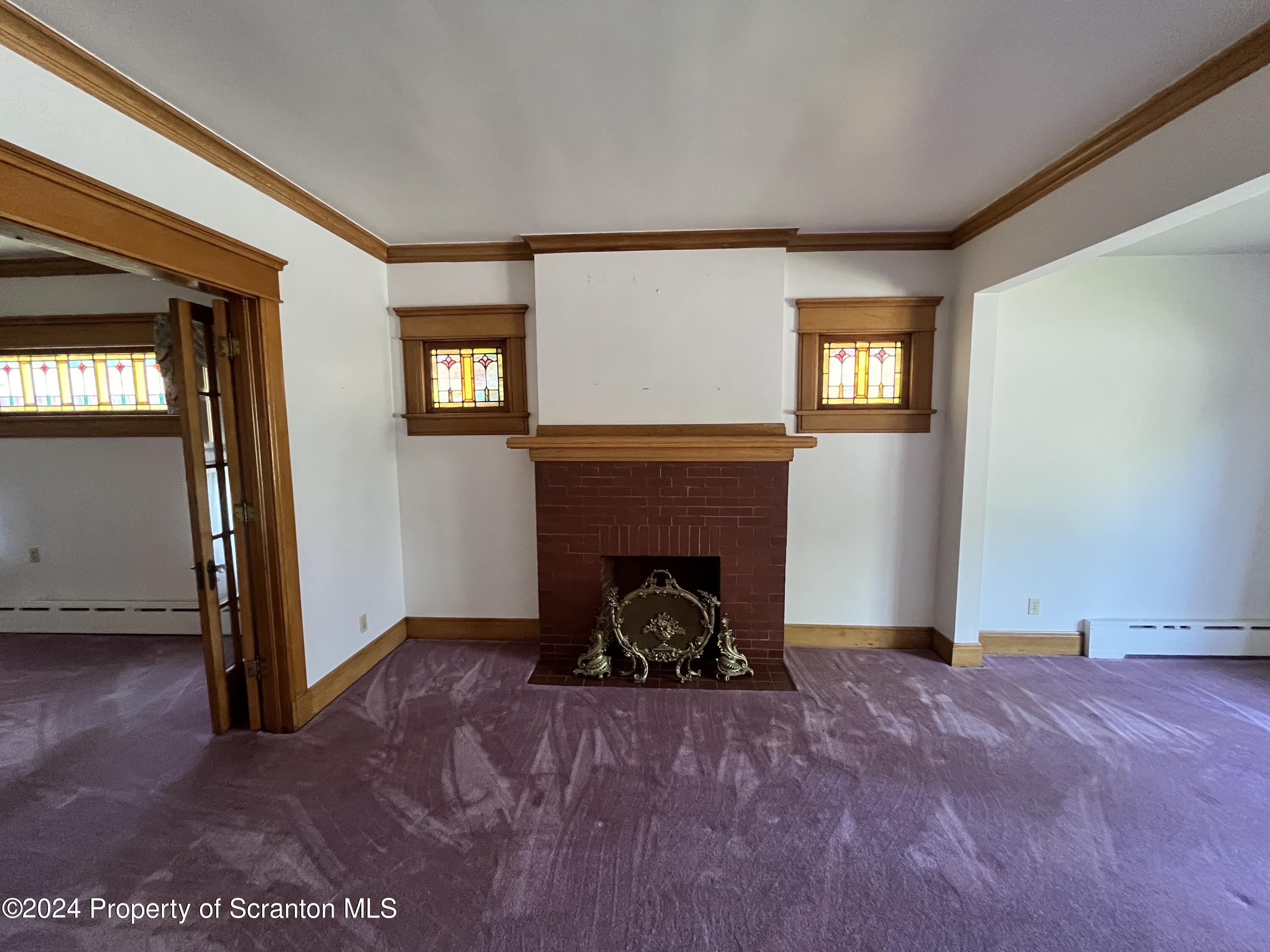 2002 Green Ridge Street Dunmore, PA 18512 - Photo 8 of 43 a view of a livingroom with a fireplace and window