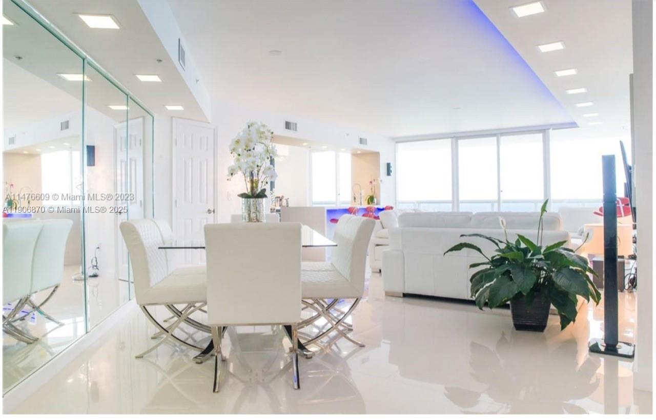 6301 Collins Avenue, Unit 1402 Miami Beach, FL 33141 - Photo 1 of 38 a dining room filled chandelier and kitchen view