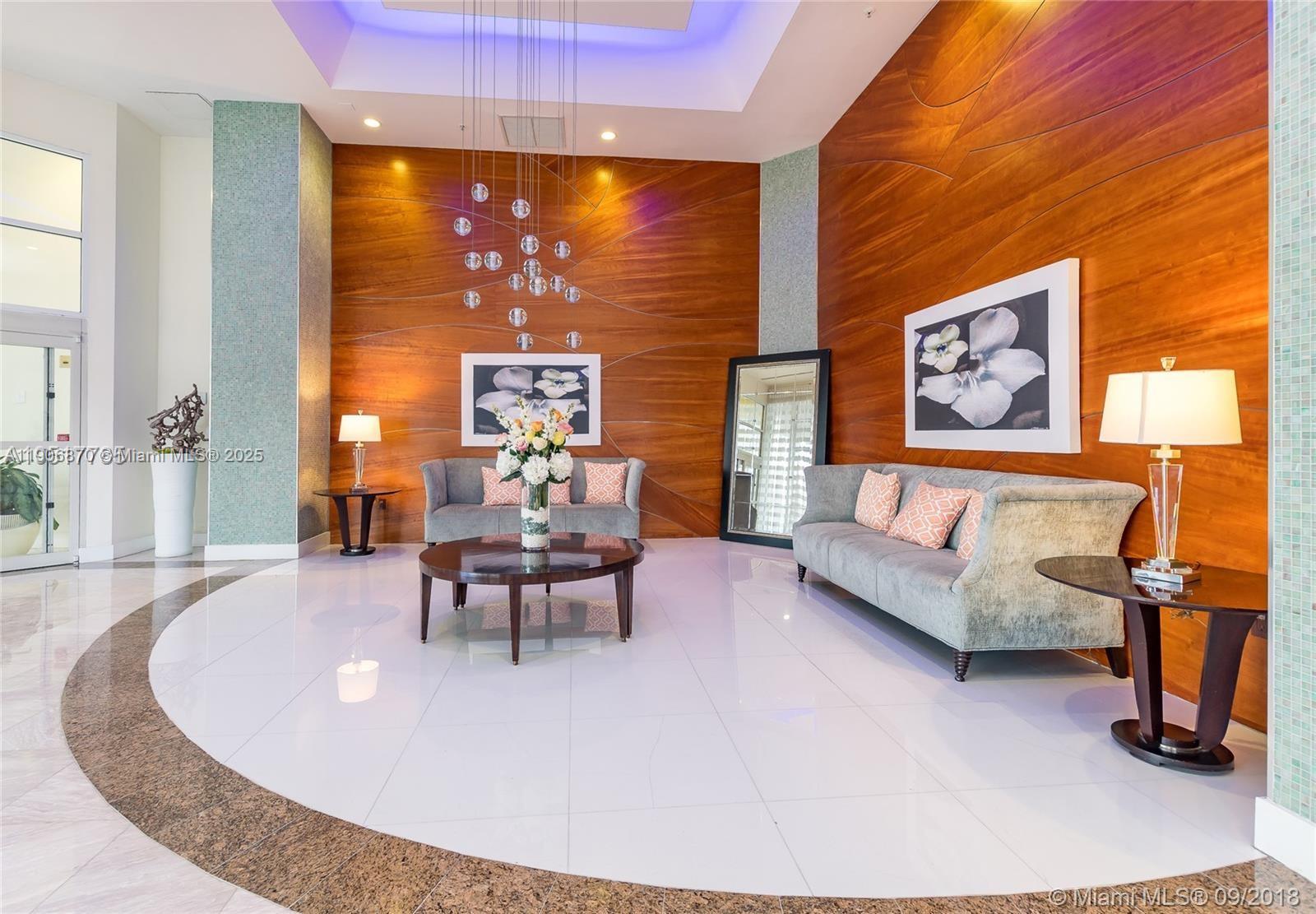 6301 Collins Avenue, Unit 1402 Miami Beach, FL 33141 - Photo 13 of 38 a living room with furniture and a large window