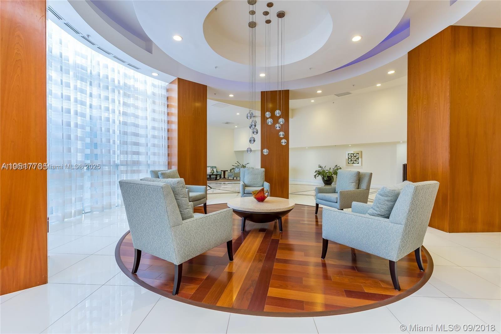 6301 Collins Avenue, Unit 1402 Miami Beach, FL 33141 - Photo 14 of 38 a living room with fireplace furniture and a large window