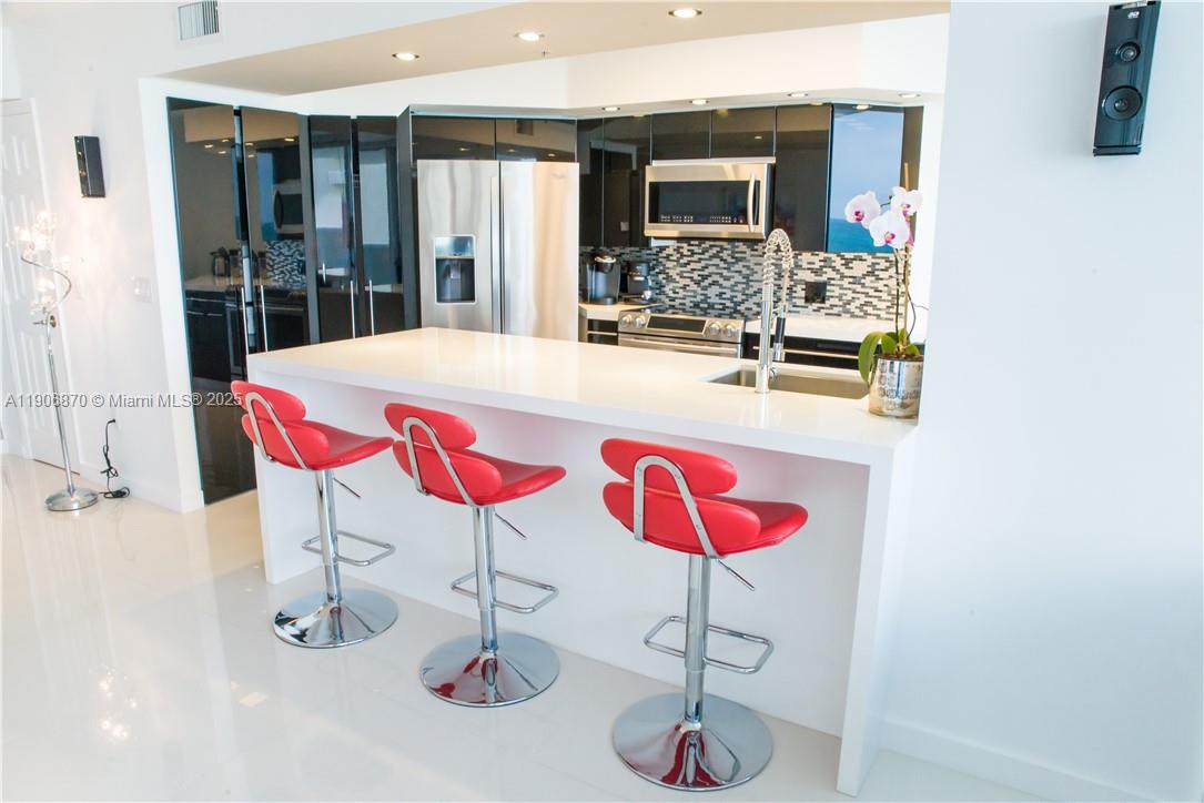 6301 Collins Avenue, Unit 1402 Miami Beach, FL 33141 - Photo 19 of 38 a bath room with a sink and view of bathroom