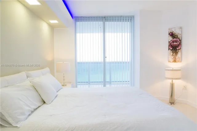 a bedroom with a bed and a lamp