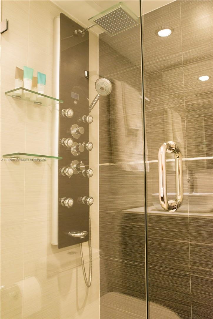 6301 Collins Avenue, Unit 1402 Miami Beach, FL 33141 - Photo 22 of 38 a bathroom with a shower and a sink