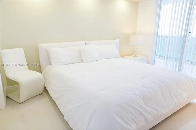 a large white bed in a white room