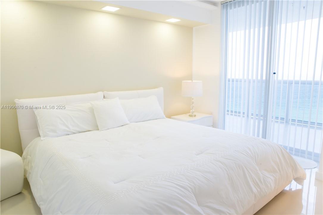 6301 Collins Avenue, Unit 1402 Miami Beach, FL 33141 - Photo 25 of 38 a large white bed in a small room